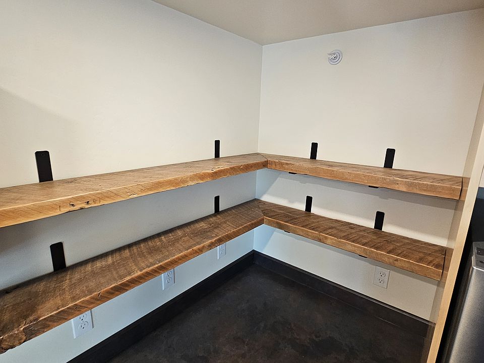 Open shelving was made from wood repurposed from the house that stood on the property.