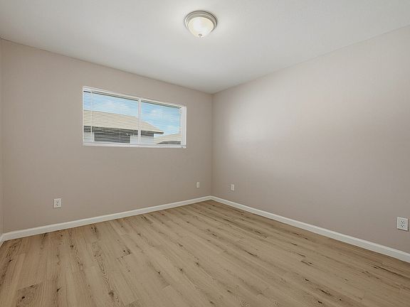 Bedroom with wood-style flooring at The Crawford at Denison.