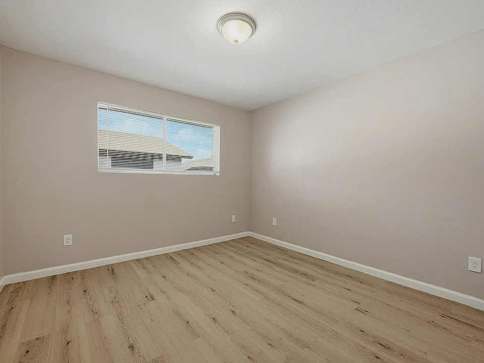 Bedroom with wood-style flooring at The Crawford at Denison.