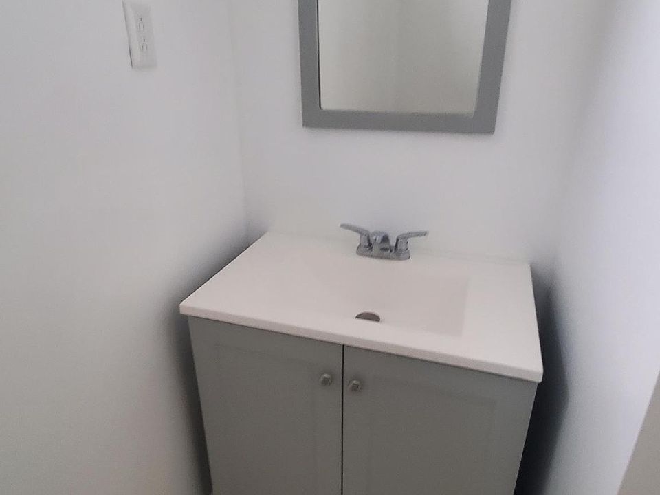 Vanity and mirror section of the large bathroom.