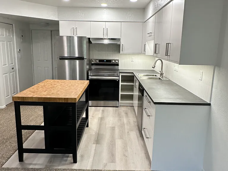 Brand new open kitchen with island / eating area. Stainless steel appliances.