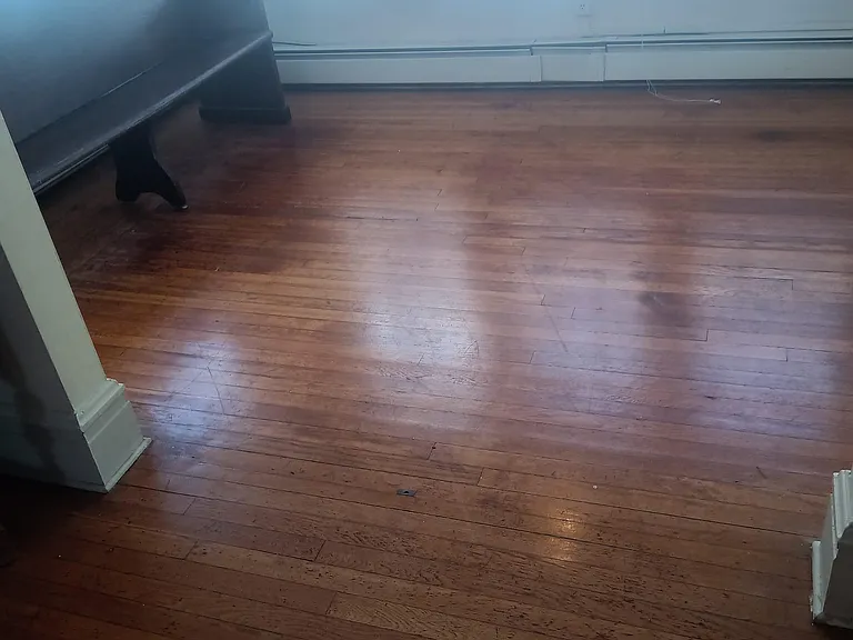 nice 1920s hardwood floors. sunny den area