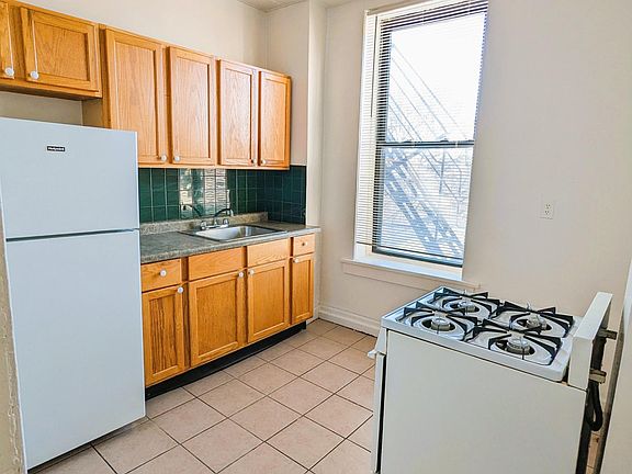 Oak Cabinets, newer tiled floor and backsplash