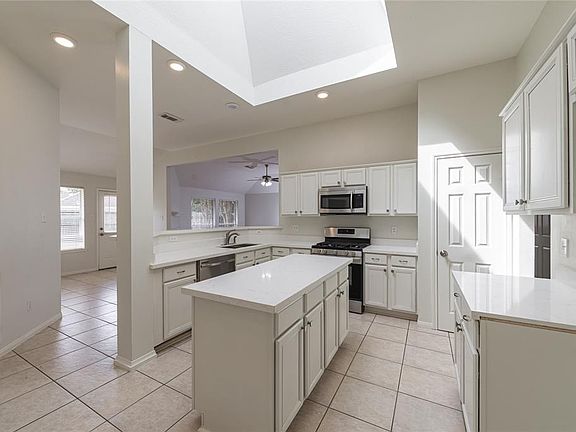 This is an amazing kitchen! Tile flooring, painted cabinets, 'new' appliances including disposal and quartz counter tops.