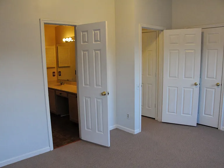 Master bedroom, looking toward upstairs hallway and bathroom.