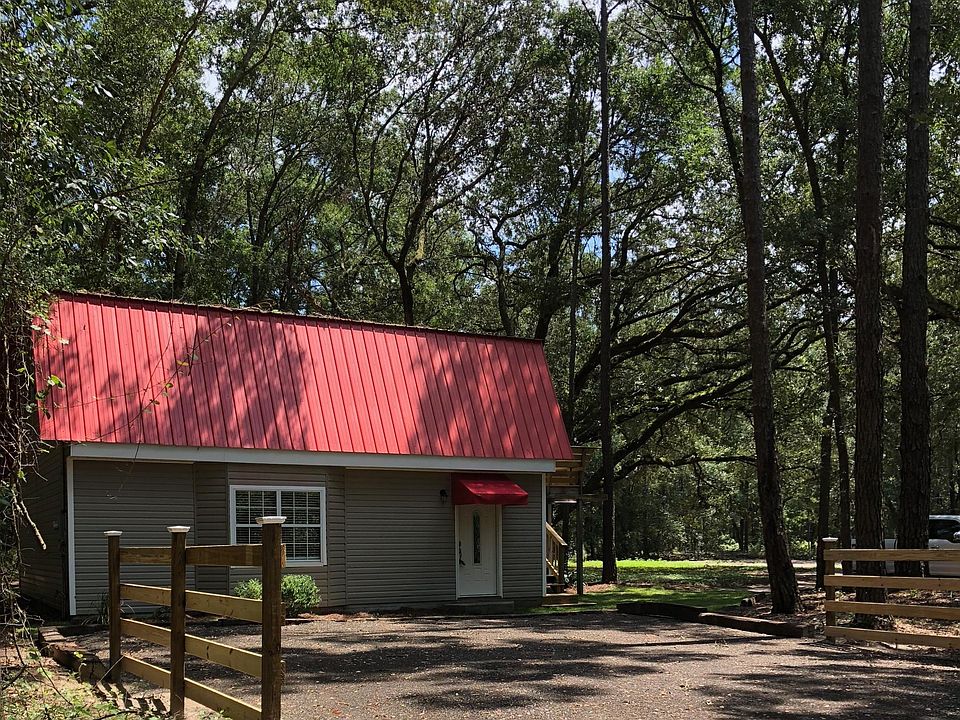 New driveway, fence, front door, sod, pine straw and awning.