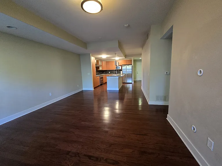 View of living room and kitchen from balcony doorway