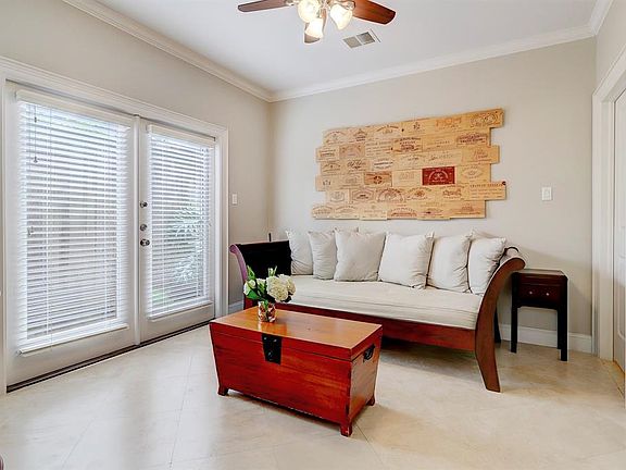 Light and bright first floor bedroom with custom installed doorway to the fenced in backyard.