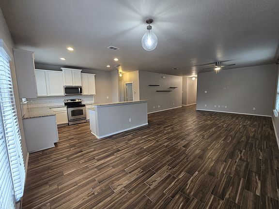The home features an open-concept layout that flows effortlessly from the entry into the living room and kitchen.