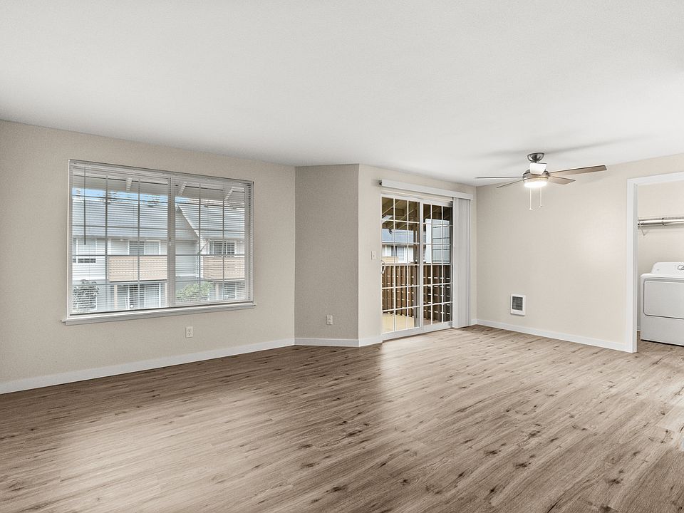 Bright and open living room with wood-style floors and private patio access.