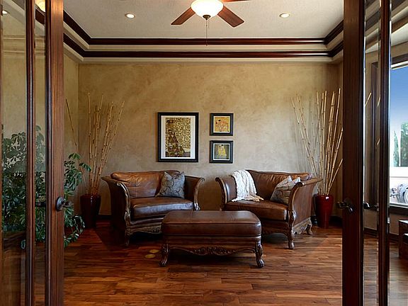 Double 8-foot custom doors open freely to the Study that offers the distinction with a raised ceiling, double crown molding, subtly noticed faux painted walls and rich wood floors