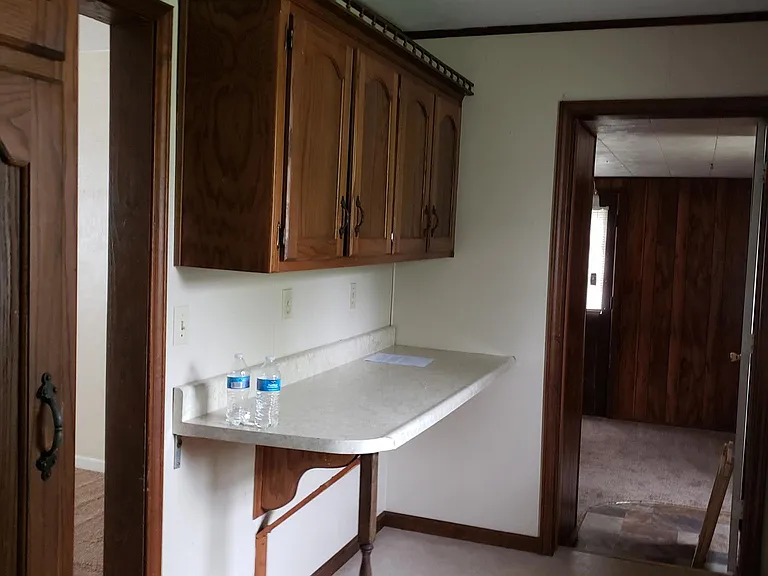 More kitchen cabinets with bar.