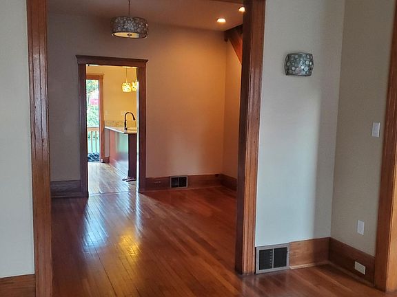 Living room looking through middle room to kitchen