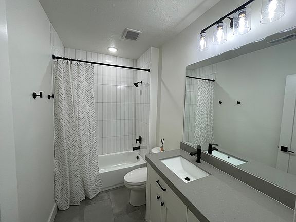 Light and bright bathroom with tile surround and floor