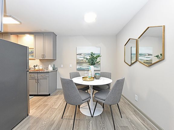 Dining area with hardwood-style flooring and overhead lighting