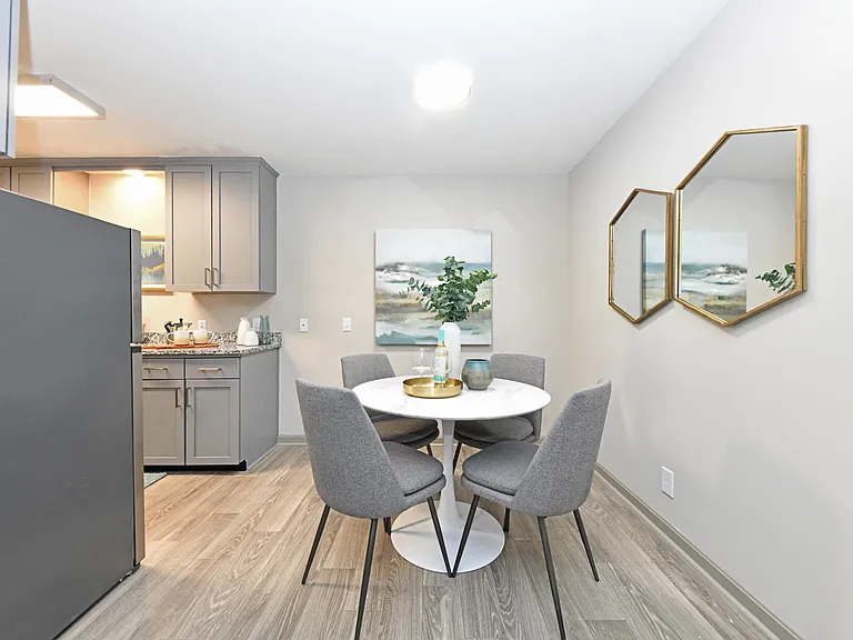 Dining area with hardwood-style flooring and overhead lighting