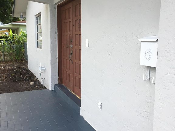 Exterior Photo with new Paint. Front door to be replaced with Impact Glass Double French Door; all Windows to be replaced w/ Impact Glass on or before August 11th. Pure White Standing Seam Metal Roof to be fully installed within this time period.