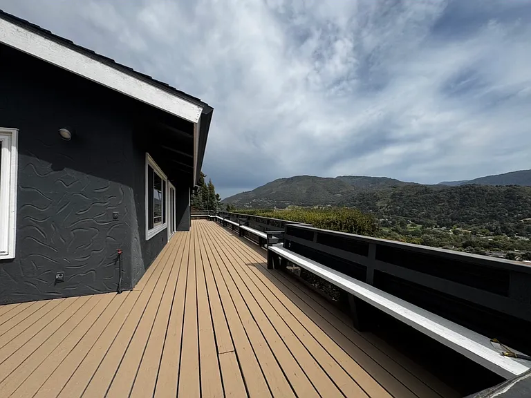 Upper-level wrap-around deck with 3 entrances, primary bedroom, living room & dining room.