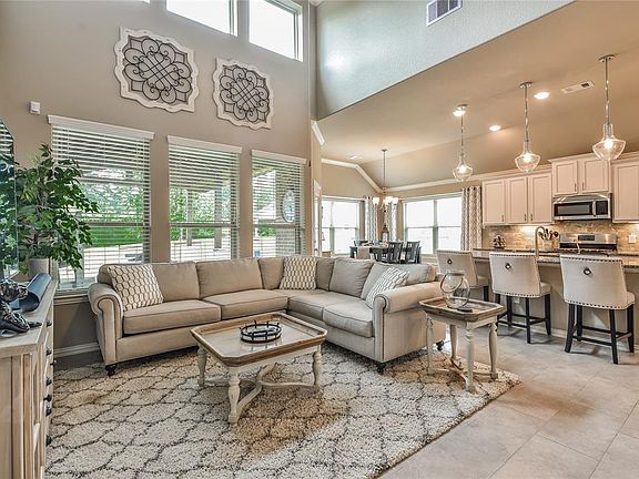 Open and fluid layout with natural light cascading through expansive windows in the family room, kitchen and dining areas.