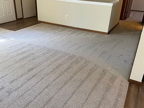 Living room view down hallway to two bedrooms and one bathroom