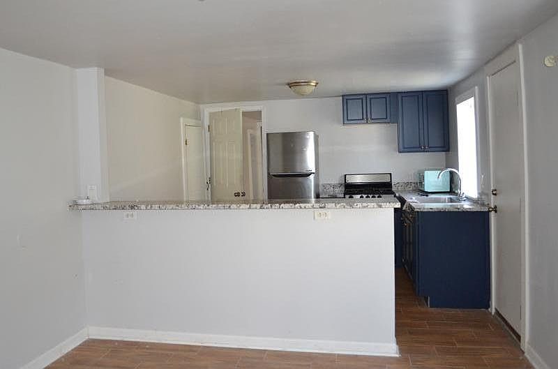 View of kitchen from living room. Kitchen has a breakfast bar!
