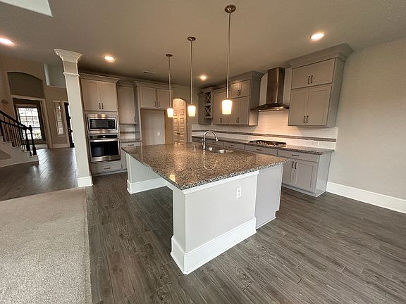 The ultimate entertainer's kitchen! The huge island offers excellent space for meal prep, serving, or just good conversation. Beautiful granite countertops Excellent cabinet space!
