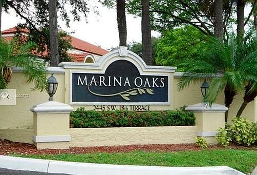 COMMUNITY ENTRANCE - TROPICAL LANDSCAPING, LARGE SHADE TREES, LOTS OF FREE PARKING