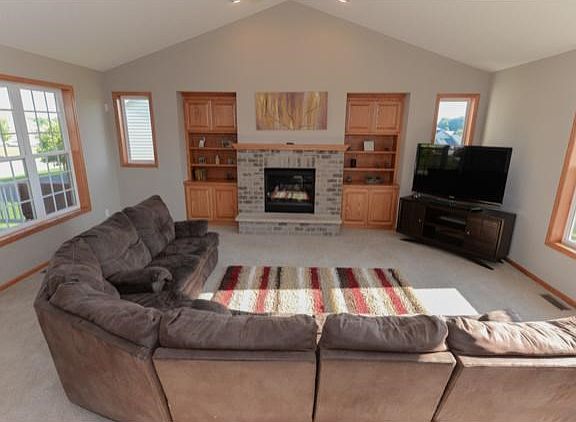 Impressive living room with vaulted ceiling, natural light and abundant space.
