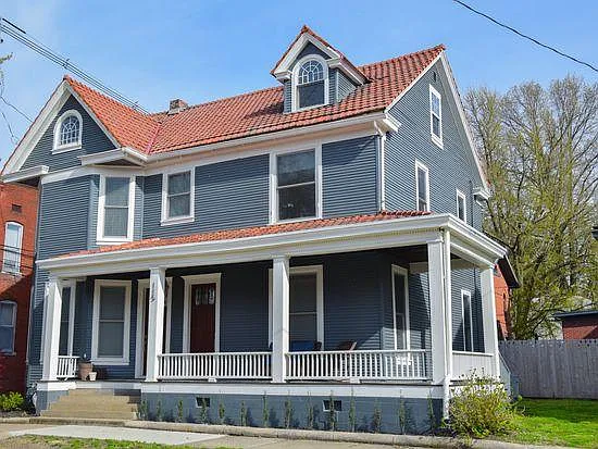 Street view of the house. Apartment spans the second and third flloors. Common area porch and side yard.