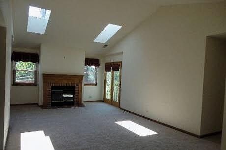 Living Room with Fireplace & Skylights