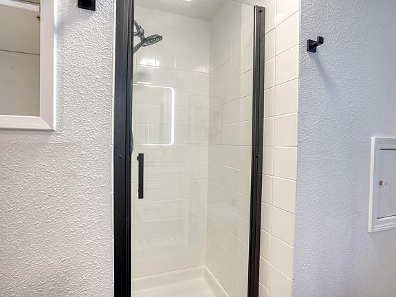 Newly remodeled bathroom with anti-fog mirrors, good water pressure and blue tooth fan for listen to that podcast or music.