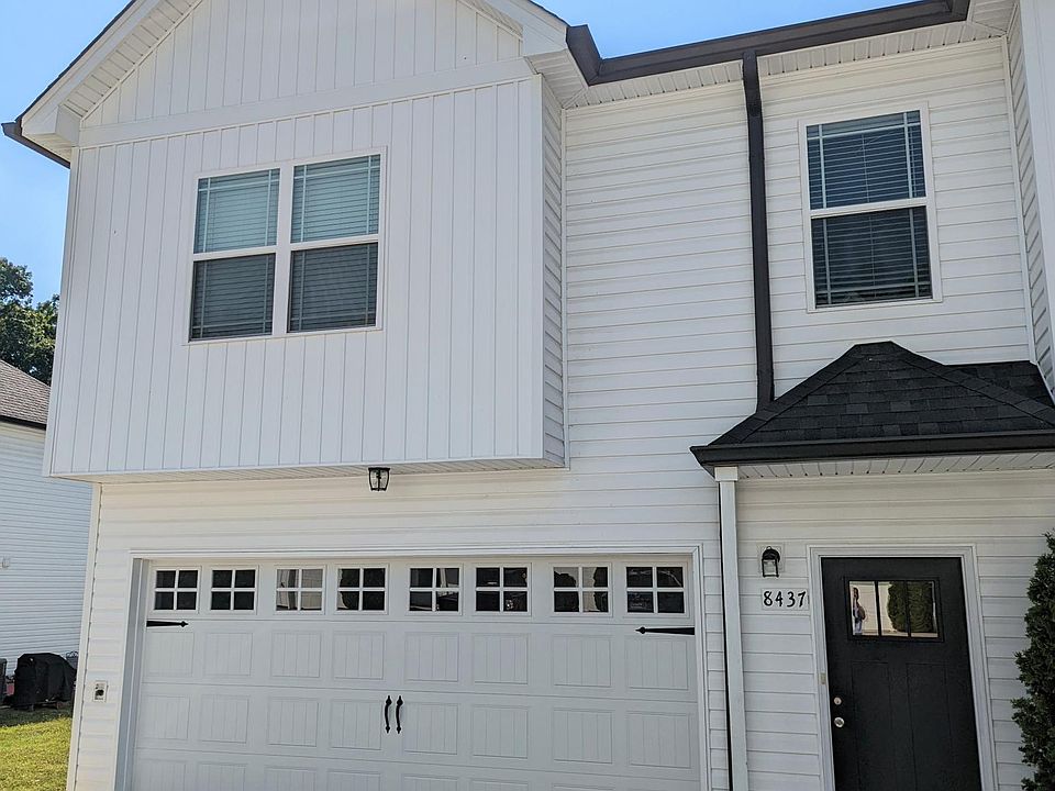 End unit home with 2 car garage and parking space in driveway and common parking for guests.