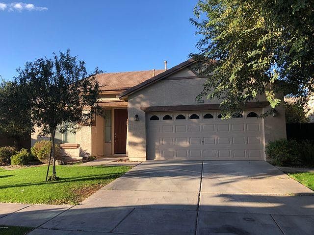 This home has a 2-car garage and sides to one of the community greenbelts on left.