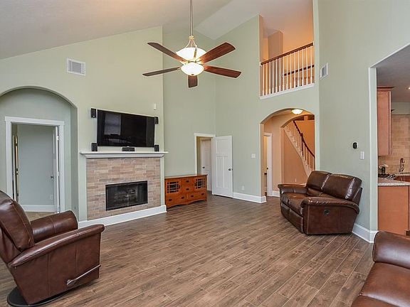The den has a gaslog fireplace and wood looking tile floors. LOVE the interior elevation of this home!