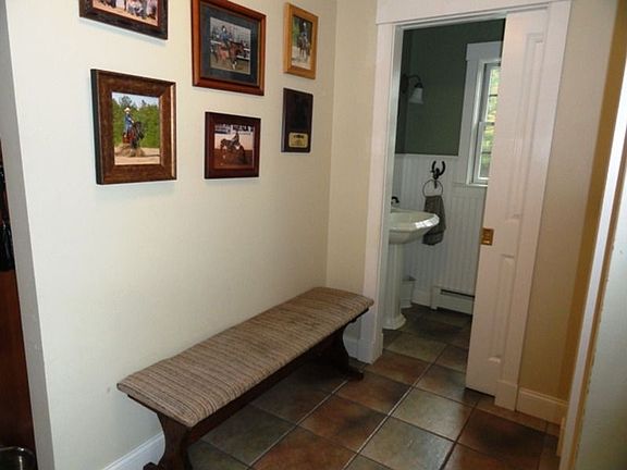 Mud room &amp; half bath w/ pocket door and tile flooring