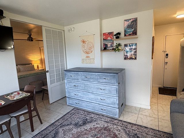 Queen-size Murphy bed, with bedroom entry and entryway to condo.