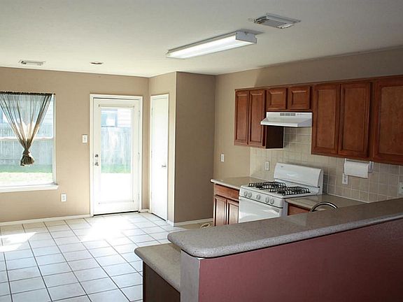 Open kitchen with large area for breakfast room over looking the backyard.