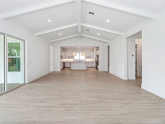 Open floorplan with vaulted ceiling ceiling beams