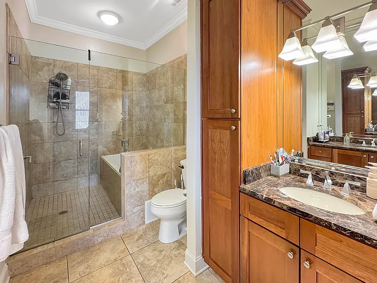 Large, modern master bathroom. Full walk in shower with new bathtub recently installed. Double sinks across from each other. Plenty of cabinet space