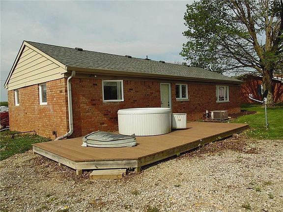 Back exterior, composite deck, exterior door into 3rd-bedroom, additional parking space! (Hot tub wi
