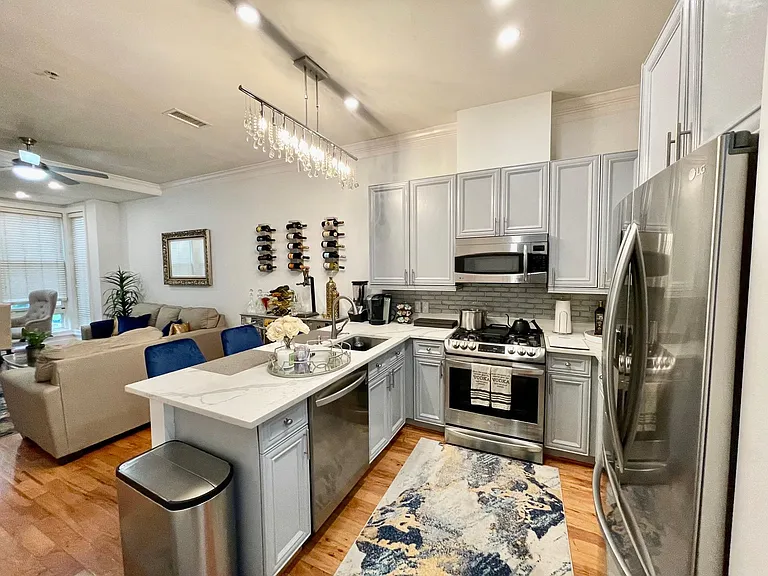 Kitchen w/ All New Stainless Steel LG Appliances, Marble Countertops and Gray Glass Backsplash,