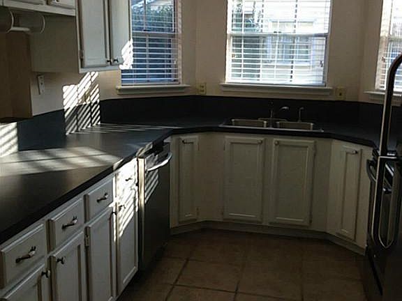 Kitchen is light and bright with lots of cabinets