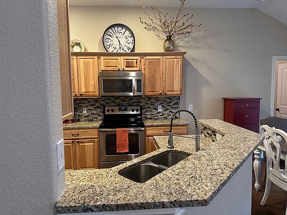 Cute modern kitchen is open to living and dining area.