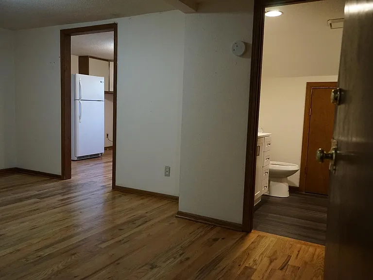 Vew of living room to bath and kitchen all new hardwood floors