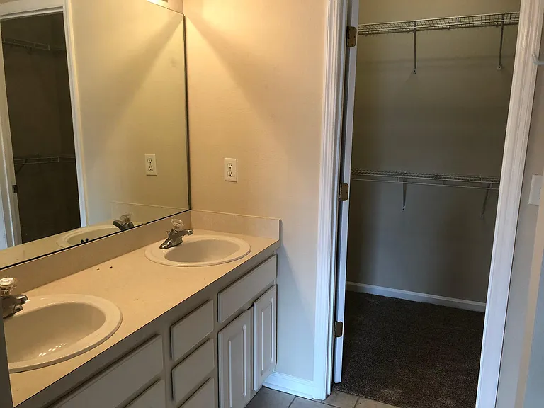 large walk in closet and double sinks in master