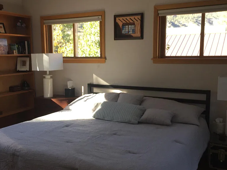 Upstairs bedroom has French doors to deck