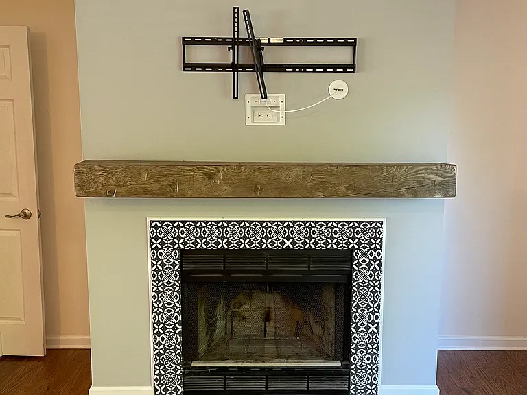 Fireplace area with mantel and tv mount