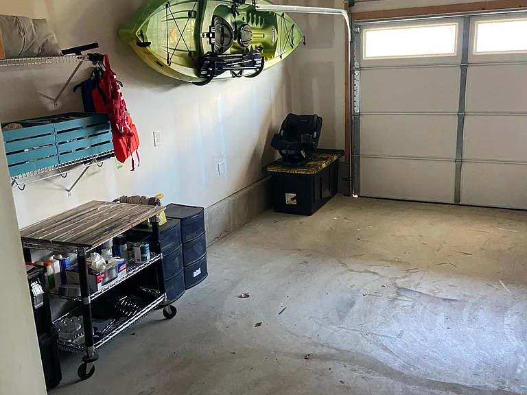 Left side of two-car garage with repurposed shelving