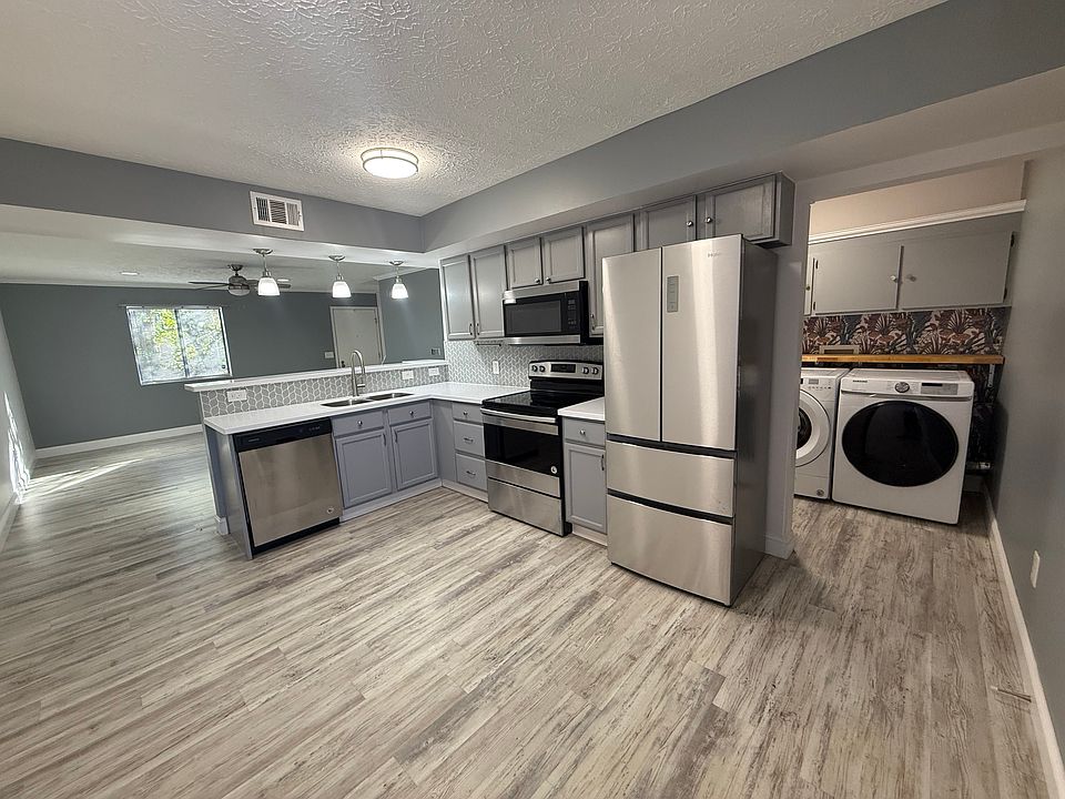 Door opens to open floor plan: kitchen