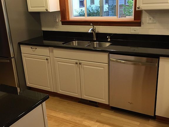 Galley Kitchen, granite, stainless, hardwoods, subway tile